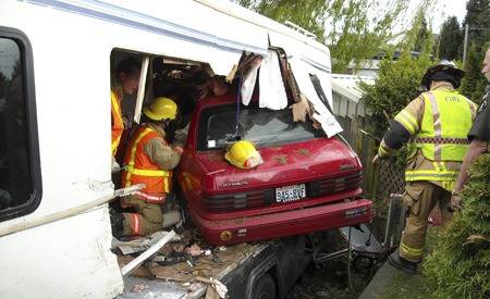 Renton fire crews helped extricate a Seattle man in his 50s early Friday afternoon from his car that crashed into a parked mobile home on Rainier Avenue South.