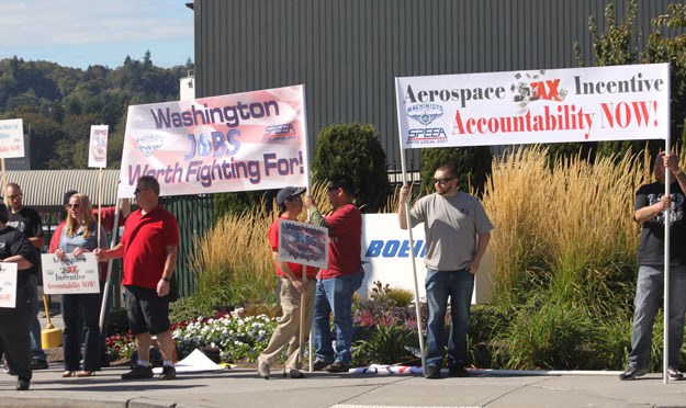 Machinists and members of SPEEA stage an informational picket outside the Renton Boeing plant Wednesday over the potential loss of jobs when a 737 finishing plant is built in China.