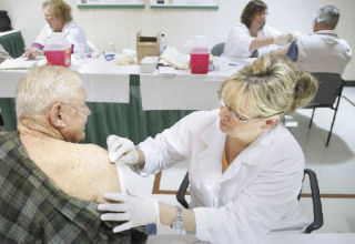 Licensed practical nurse Janine Tonge gives a flu shot to Gary Lucker Wednesday at Valley Medical Center. Today (Saturday) is the last day for flu shots at the hospital. Shots are available from 9 a.m. to 1 p.m. to members of the community aged 62 and older.