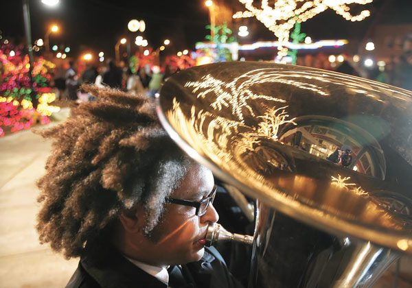 Bee Bryant plays tuba with the Salvation Army Brass Band Saturday at a holiday kickoff celebration at the Piazza in downtown Renton.