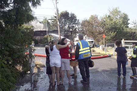 Homeowner Debbie Hillestad (in red shirt) is comforted Thursday morning after a fire destroyed the home just off Benson Road she shared with her husband Steve and eight children.