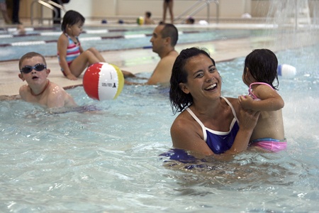 Renton's Andrea Dombroski holds her daughter Avie Dombroski at the Coal Creek YMCA. The new branch opened Aug. 7