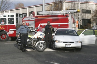Renton Police officers take measurements as part of an investigation of an accident early Friday afternoon that left a Renton Police motorcycle officer injured.