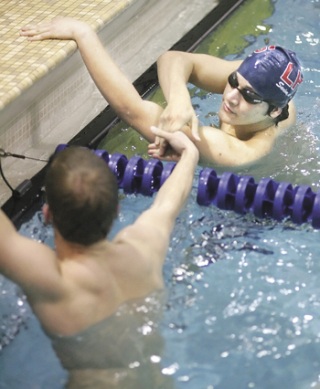 Linbergh’s Manuel Roman shakes a competitor’s hand after winning the 50-yard freestyle in the All-City Swim Meet Dec. 16 at Hazen.