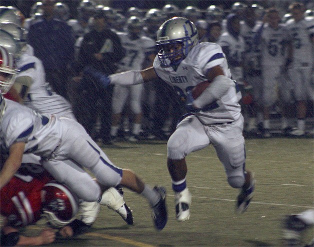 Liberty's Chandler Jenkins rushes through Kennedy's defense and the rain during the Patriots playoff win Nov. 5.