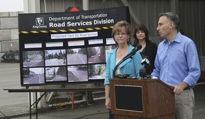 King County Executive Dow Constantine explains a new tiered approach to maintaining county roads at a press conference Monday at the county's road-maintenance field office in Renton. At left is Kathy Lambert