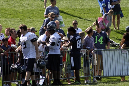 Seahawks players sign autographs and converse with fans after Monday morning's open training camp practice at the VMAC.