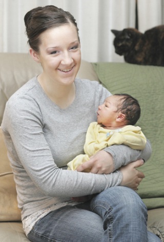 New mother Ashlyn Nearing of Renton holds her son