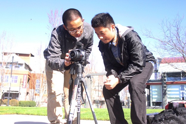 Tyvon Tabadero and Coi Tran line up a shot at the Piazza in downtown Renton March 30 as part of the SIFF Crash Cinema challenge.