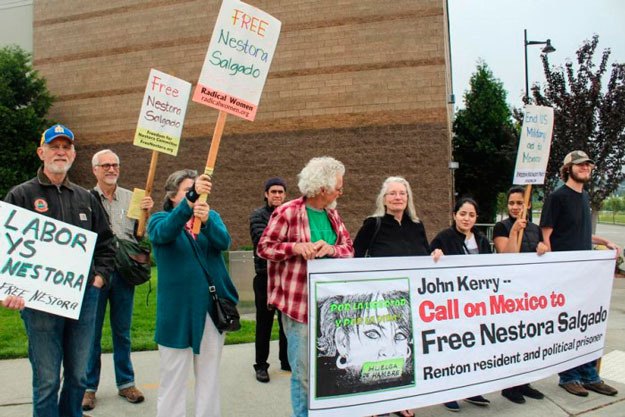 Supporters of Nestora Salgado protest during Secretary of State John Kerry's visit to Renton May 19.