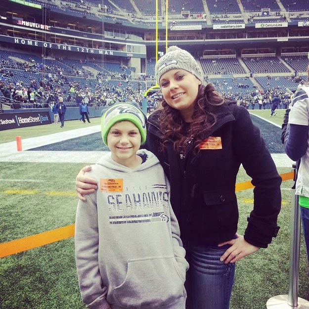 Mother and son Antonio Pebworth and Olivia Gonzales pose at Century Link field during a stress-free day away from cancer.