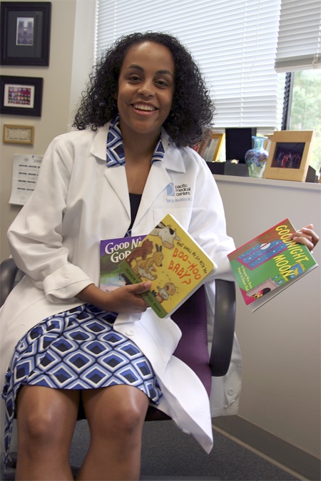 Sonja Maddox holds some of the books she gives to children when they come for a checkup. The Pacific Medical Center decided to participate in Reach out and Read
