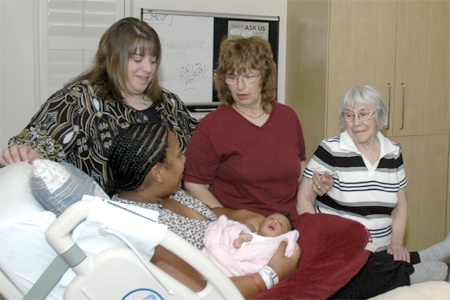 Whitney King holds her newborn daughter Heaven Lee King. Behind from the left is Michelle Fredell McDaughtery (Grandmother)