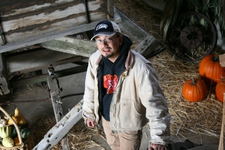 Dehvee Enciso stands next to an antique wagon in the barn of Enciso farms. Dehvee opened Enciso Farms with his wife Melissa Enciso about three years ago.