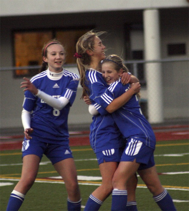 Liberty's Kailiana Johnson (right) celebrates with teammates Kiana Hafferty (middle) and Kali Youngdahl after scoring a goal against Eastside Catholic in the 3A state semifinals Nov. 18.