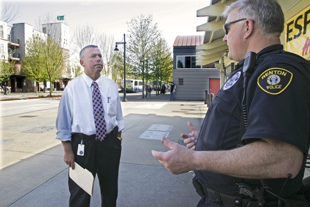 Renton City Council member Rich Zwicker checks in with Renton Police Officer Jeff Reynolds