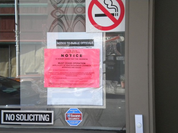 The red tag placed near the door of the Tranquility Holistic Center on South Third Street covers up a document stating that city officials do not have consent to enter and no one in the facility will answer questions about the activities on the premises.