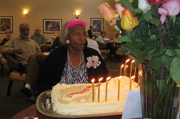 Geraldine McQuiller blows out the candles at her 100th birthday party.