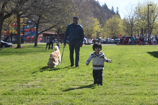 Krishna Iyer and Dexter the golden retriever chase after Kirshna's son