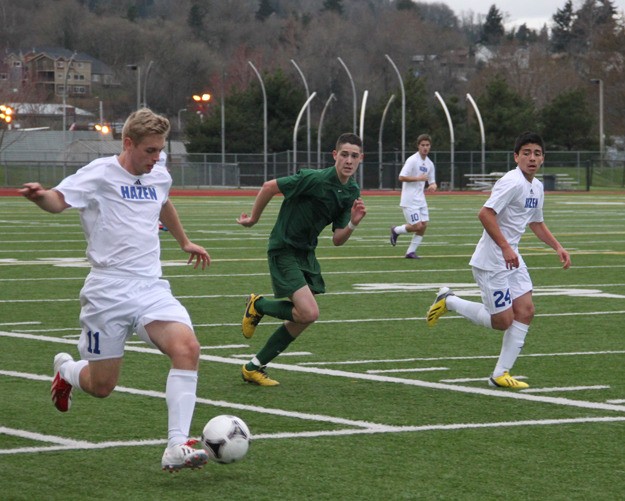 Sam Bunnell (11) leads Hazen down the pitch at Renton Memorial Stadium during the Highlanders' 2-0 victory over Evergreen March 15.