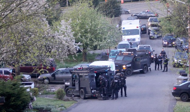 SWAT teams mass on Earlington Hill in preparation for a narcotics raid that pulled 23 people from a single home.