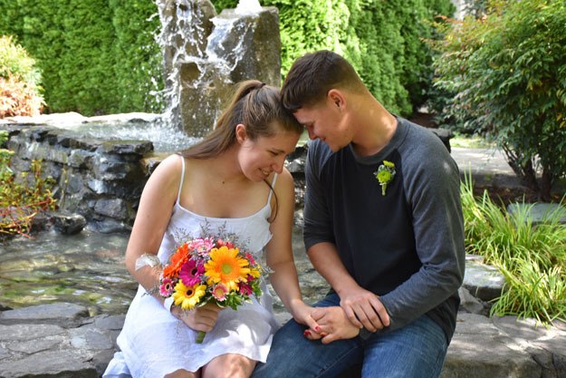 Newlyweds Heather Airth and Zachary Hoydic pose for a photo in the Healing Garden at Valley Medical Center