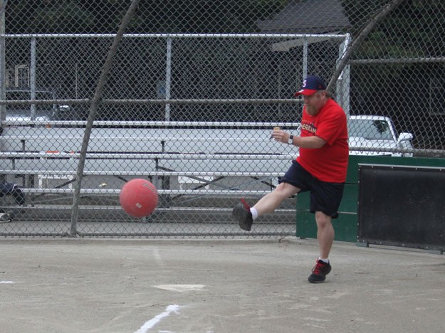 Eddie Dudek blasts one out to mid-field as he warms up before a game in Renton’s first adult kickball co-ed league.