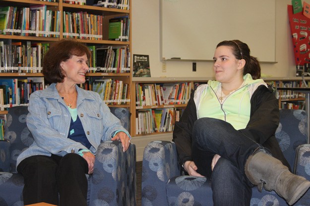 Susan Hopkins and Nitsa Kalasountas share a moment recently at the library of the Secondary Learning Center. Hopkins has been Kalasountas's mentor for almost 12 years.