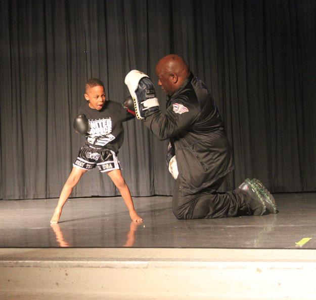 Jalani Wilson-Daraja demonstrates Thai Boxing with his uncle Tirrell in Hazelwood Elementary School's talent show on April 17.