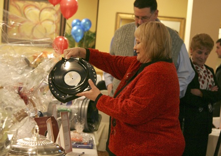 Mystie Biggs discovers a purse made from a record at a Renton Chamber of Commerce holiday auction