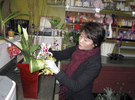 Mai Flowers Design shop owner LeVinh Tran creats floral arrangements for birthdays