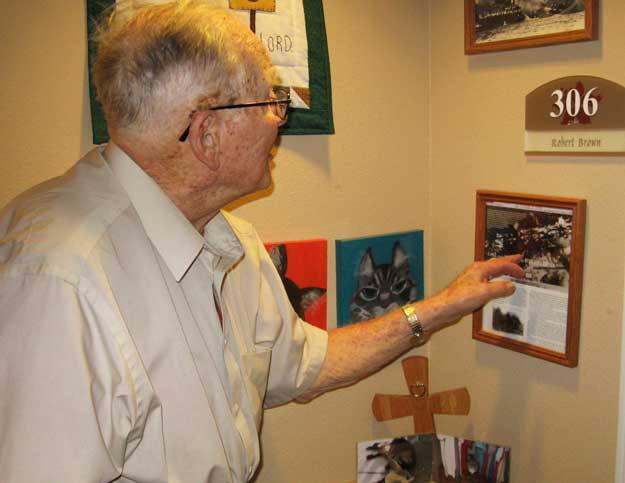 Pearl Harbor survivor Robert Brown points to a picture of his ship