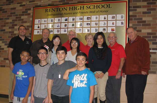 Members of the Friends of Renton High School pose with members of the school’s DECA Club in front of the Wall of Fame at Renton High School. The kids