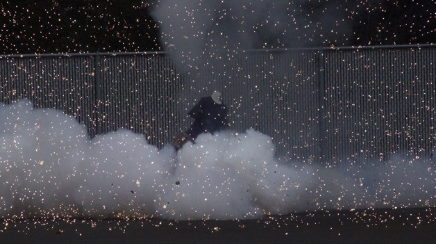 A dummy is surrounded by smoke and sparks after an illegal explosive device was discharged Tuesday in a demonstration in Renton to show the danger of such devices. MIDDLE: An illegal fireworks blows off the dummy's hand. BELOW: Craig Mabie with the U.S. Consumer Product Safety Commission inspects the damage.
