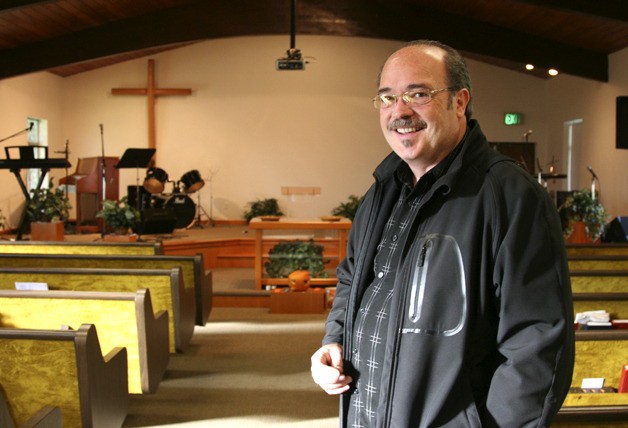 Pastor Don Burnett of Evergreen Community Church stands in the church sanctuary