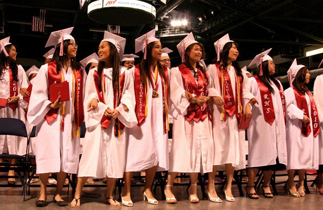 Renton High School seniors stand together after accepting their diplomas at the ShoWare Center in Kent June 15.