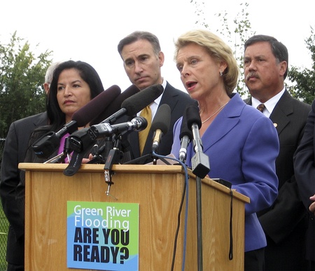 Gov. Christine Gregoire talks about flood preparation plans at a press conference Monday along the Green River next to the Riverbend Golf Course in Kent. She is flanked