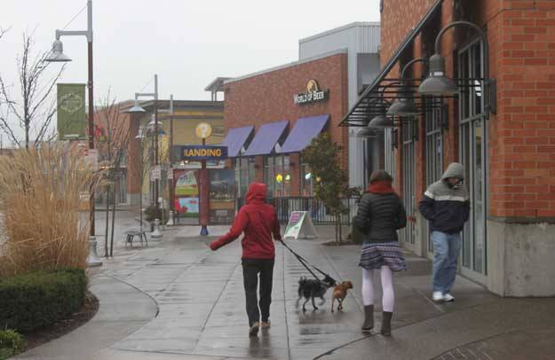 Shoppers dodge raindrops this week at The Landing.