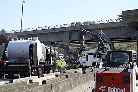 Crews began demolishing the old Renton Road bridge over Interstate 405 at about 4:20 a.m. Saturday. The bridge was removed by 10 a.m. The freeway will remain closed through 11 a.m. Sunday