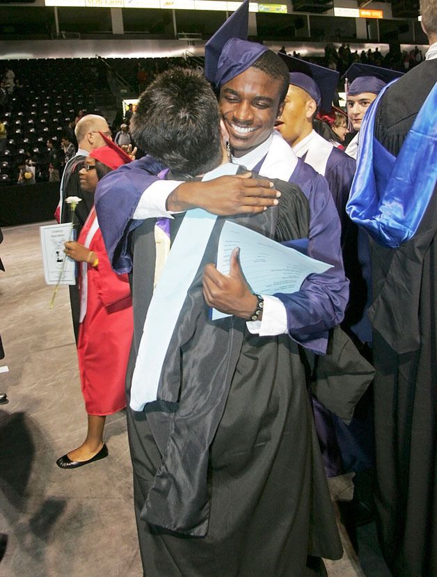 06/15/10 Lindbergh graduate Devan Bickman hugs his drama teacher Ginger Montague during the recessional after the Lindbergh Commencement at ShoWare Tuesday