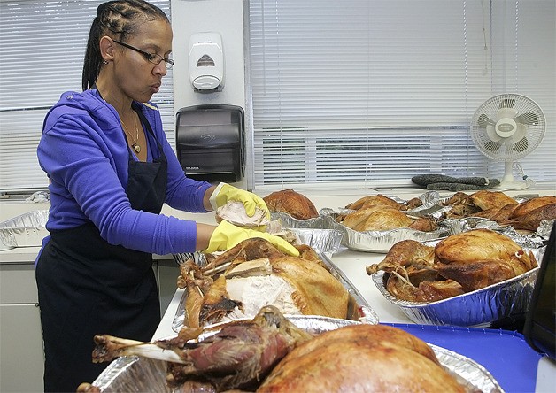 Assistant principal Dr. Elaine Love starts de-boning one of her 17 turkeys