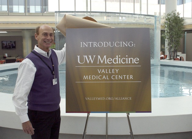 Valley Medical Center CEO Rich Roodman unveils the new logo for the alliance between Valley Medical Center and UW Medicine.