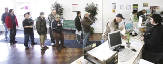 People wait in line at the Vehicle Licensing office in Renton Tuesday.