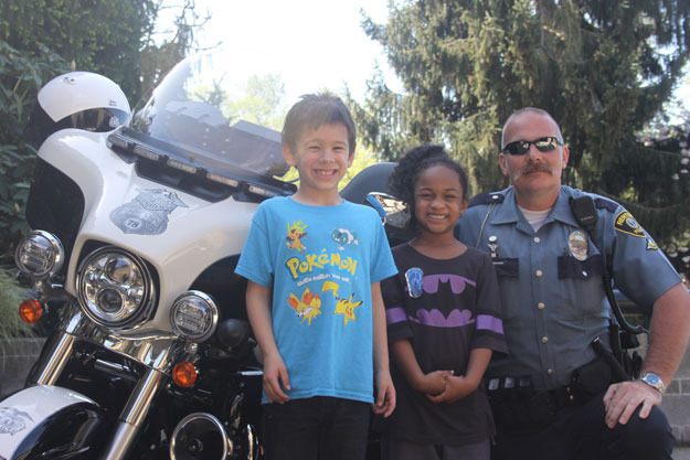 Officer Marty Leverton was giving kids a closer look at the Renton Police Department motorcycle at the Cops