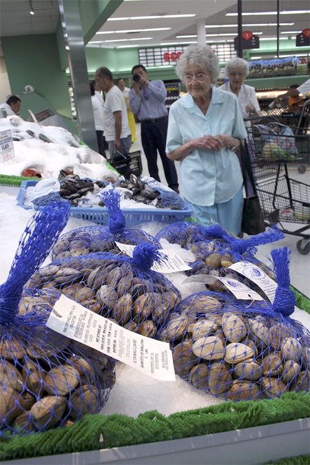 Renton’s Ninfa Gregoris  checks out the seafood at the soft opening of Uwajimaya’s Wednesday. Though many shelves hadn’t been stocked