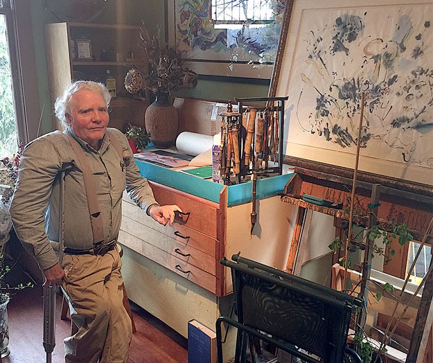 Artist Louis Anderson poses near one of his watercolors. Anderson is a prolific painter who says his work 'keeps getting better' with age.