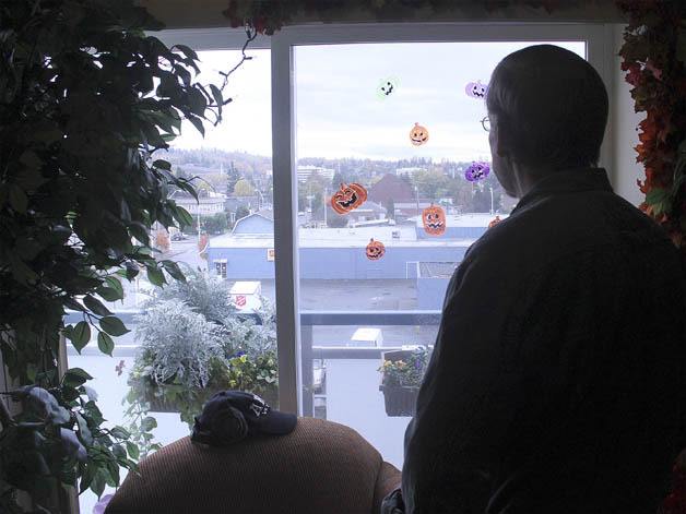 A veteran living at the Compass Center admires the view overlooking downtown Renton out of his apartment window.