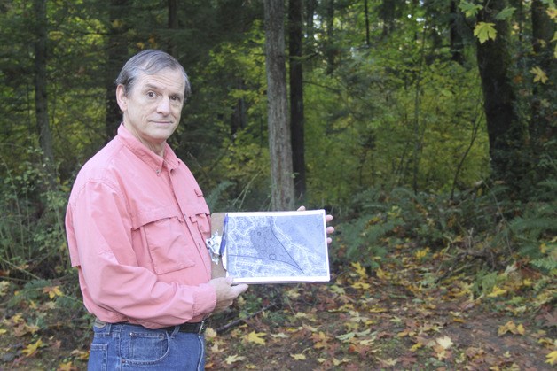 Dave Beedon holds a map of the trails that run through an undeveloped property near Tiffany Park Elementary School