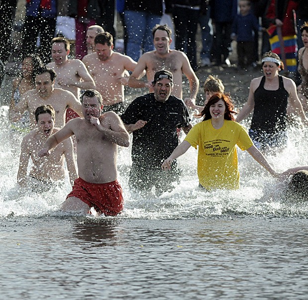 Brave swimmers race into a chilly Lake Washington during a recent Polar Bear Dip.