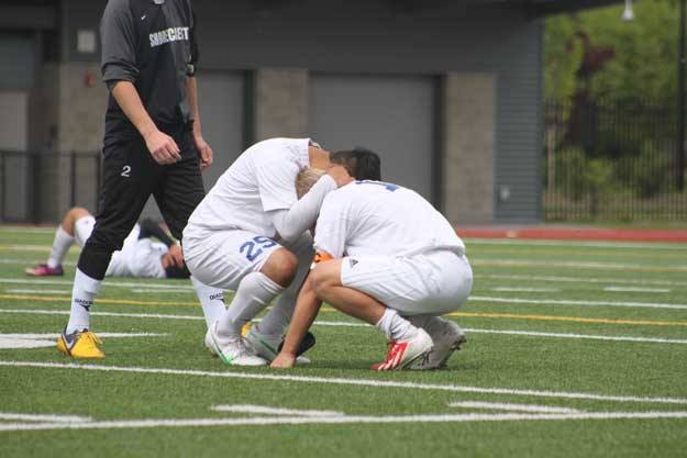 Hazen seniors Eric Tim and Sam Bunnell console each other after Saturday's quarterfinal loss to Shorecrest.